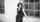 artist dressed in black standing in front of window frame